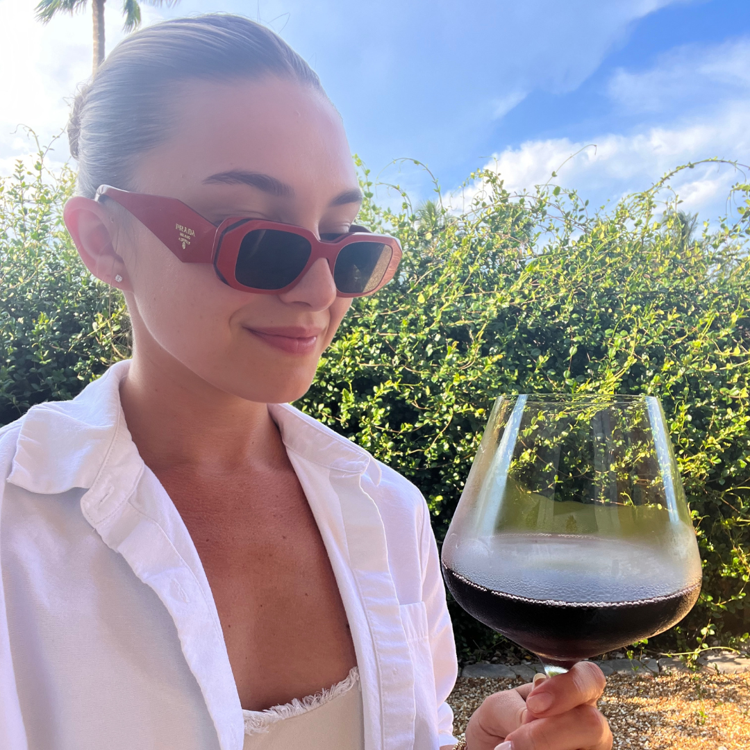 A person drinking red wine